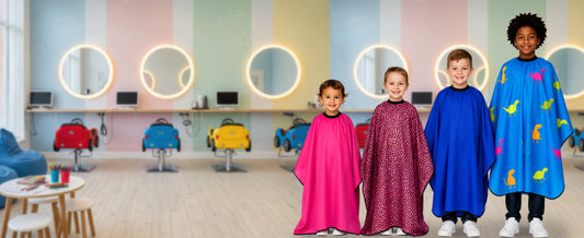 Children wearing Allegro Combs Kids Hair Cutting Capes in pink, leopard, blue, and dino print at a colorful kids salon